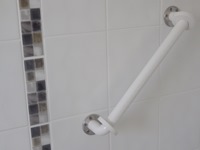 Safety Hand Rail fixed to shower tiled wall using self aligning Scorpion wall plugs