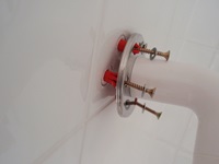 Safety Hand Rail fixed to shower tiled wall using self aligning Scorpion wall plugs and screws
