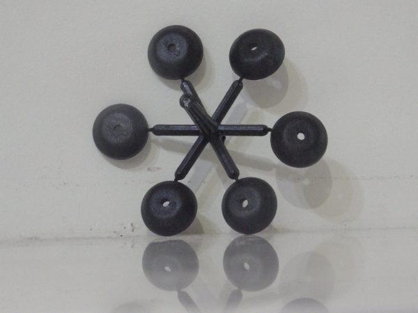 Black polypropylene Screw Protector to suit 8mm Dia. Cap Head Bolts with 6mm Hex Head shown attached on moulding sprue